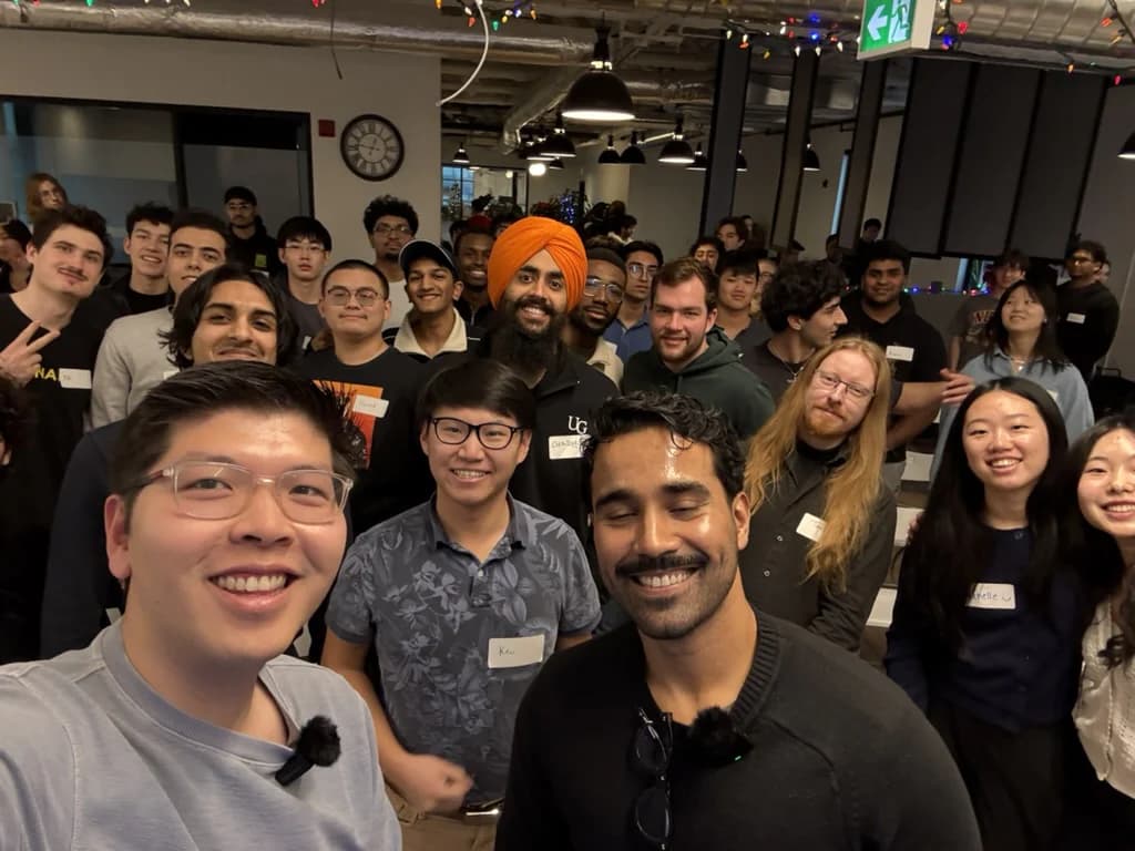 Jerry Jiang taking a group selfie with a Waterloo founder and students at an event.
